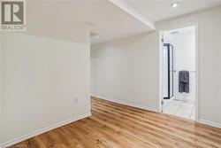 Unfurnished room with light hardwood / wood-style floors - 