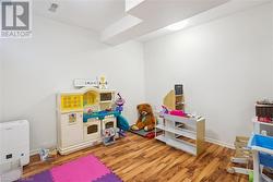 Recreation room featuring hardwood / wood-style flooring - 