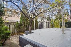 Wooden deck featuring a storage shed - 