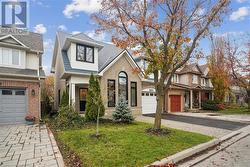 View of front of home featuring a garage and a front lawn - 