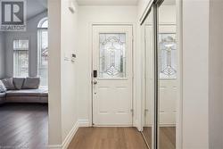 Foyer featuring hardwood / wood-style flooring and lofted ceiling - 