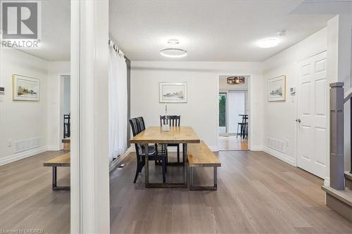 Dining room featuring hardwood / wood-style floors and a textured ceiling - 5021 Bunton Crescent, Burlington, ON - Indoor Photo Showing Dining Room