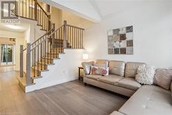 Living room with wood-type flooring and vaulted ceiling - 