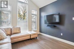 Living room with hardwood / wood-style floors and lofted ceiling - 