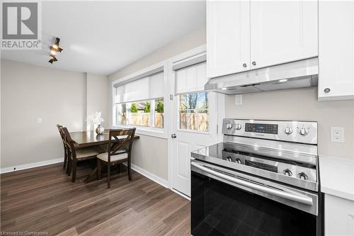 Kitchen featuring white cabinets, dark hardwood / wood-style flooring, and stainless steel electric range oven - 305 East 24Th Street, Hamilton, ON - Indoor Photo Showing Kitchen