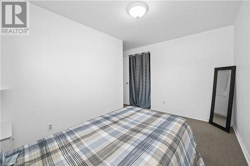 Unfurnished bedroom featuring light carpet - 305 East 24Th Street, Hamilton, ON - Indoor Photo Showing Bedroom