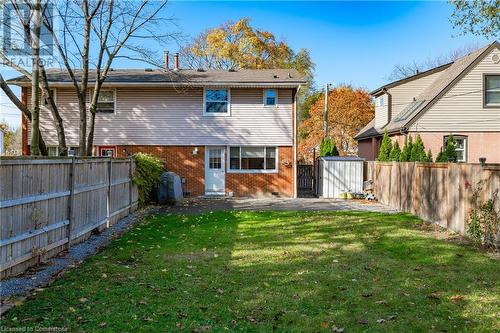 Back of house featuring a patio area, a yard, and a storage shed - 305 East 24Th Street, Hamilton, ON - Outdoor