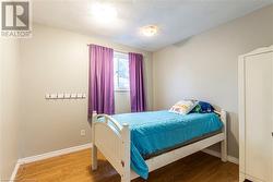 Bedroom featuring wood-type flooring and a textured ceiling - 