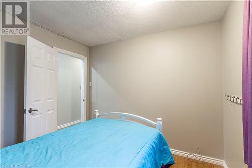 Bedroom featuring a textured ceiling and hardwood / wood-style flooring - 39 Keewatin Avenue, Kitchener, ON - Indoor Photo Showing Bedroom