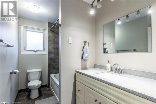 Full bathroom with tile patterned floors, vanity, tiled shower / bath combo, and toilet - 39 Keewatin Avenue, Kitchener, ON - Indoor Photo Showing Bathroom