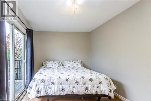 Bedroom with access to exterior and wood-type flooring - 39 Keewatin Avenue, Kitchener, ON - Indoor Photo Showing Bedroom