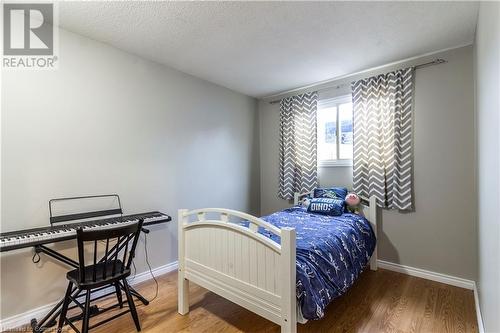 Bedroom with wood-type flooring and a textured ceiling - 39 Keewatin Avenue, Kitchener, ON - Indoor Photo Showing Bedroom