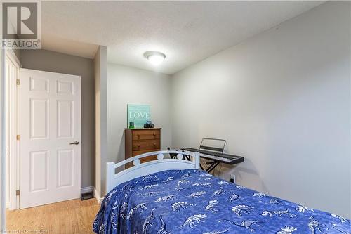 Bedroom featuring hardwood / wood-style floors and a textured ceiling - 39 Keewatin Avenue, Kitchener, ON - Indoor Photo Showing Bedroom