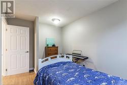 Bedroom featuring hardwood / wood-style floors and a textured ceiling - 