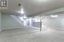 Basement featuring light carpet - 