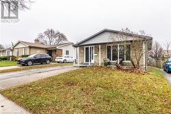 View of front of home featuring covered porch and a front lawn - 