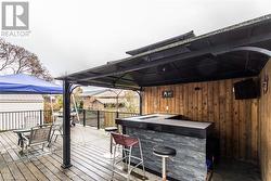 Deck featuring a gazebo and exterior bar - 