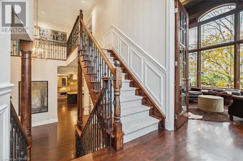 Stairway featuring a high ceiling, hardwood / wood-style flooring, a wealth of natural light, and ornamental molding - 1143 Riverbank Way, Oakville, ON 