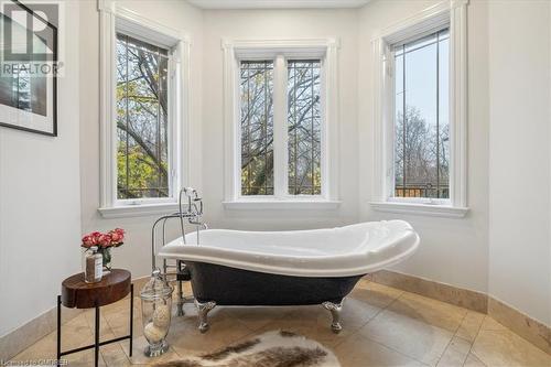 Bathroom featuring tile patterned floors and a bath - 1143 Riverbank Way, Oakville, ON 