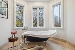 Bathroom featuring tile patterned floors and a bath - 