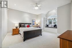 Carpeted bedroom featuring ceiling fan - 