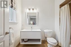 Bathroom featuring vanity, wood-type flooring, and toilet - 