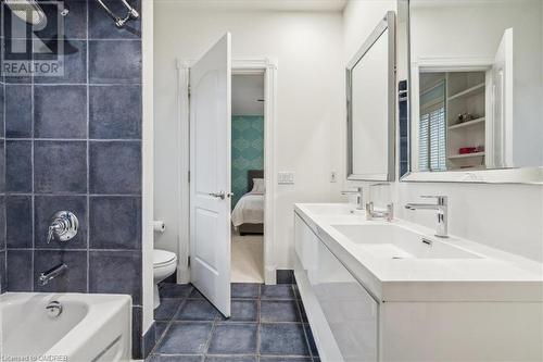 Full bathroom featuring tile patterned flooring, tiled shower / bath combo, toilet, and vanity - 1143 Riverbank Way, Oakville, ON 