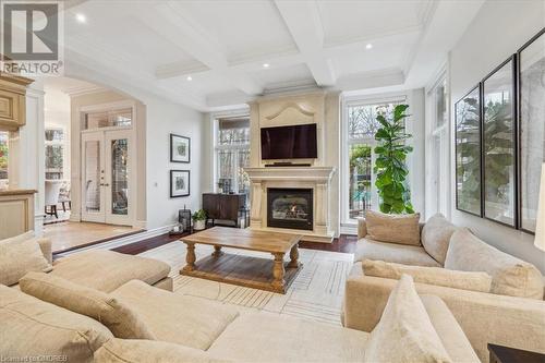 Living room featuring french doors, beamed ceiling, light hardwood / wood-style floors, and coffered ceiling - 1143 Riverbank Way, Oakville, ON 