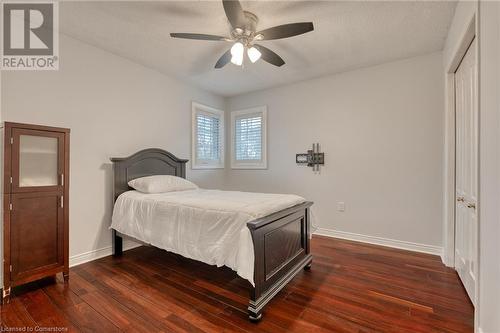 Bedroom with a textured ceiling, dark hardwood / wood-style flooring, a closet, and ceiling fan - 146 Kitty Murray Lane, Ancaster, ON - Indoor Photo Showing Bedroom