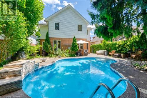 View of swimming pool featuring pool water feature and a patio - 146 Kitty Murray Lane, Ancaster, ON - Outdoor With In Ground Pool With Backyard With Exterior