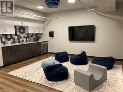 Living room featuring hardwood / wood-style floors and sink - 