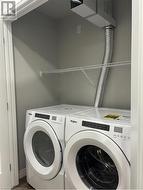 Washroom with washing machine and clothes dryer - 