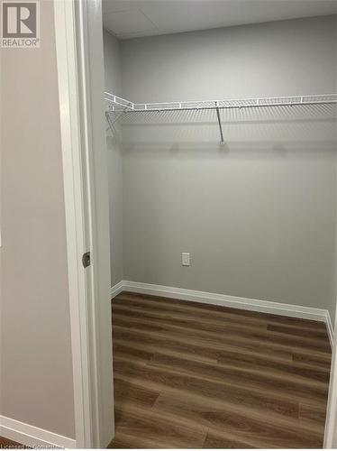 Walk in closet with dark wood-type flooring - 28 Westhill Drive Unit# 206, Waterloo, ON - Indoor With Storage