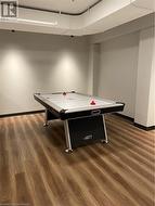 Recreation room with dark wood-type flooring - 