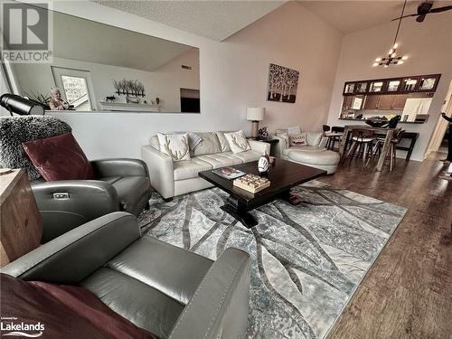 Living room featuring dark wood-type flooring, high vaulted ceiling, and a chandelier - 231 Grandview/Hilltop Drive, Huntsville, ON - Indoor Photo Showing Living Room