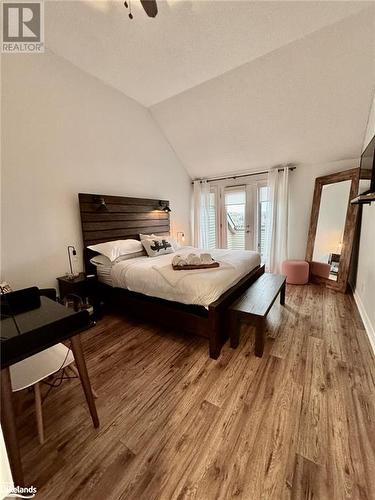 Bedroom featuring hardwood / wood-style flooring, ceiling fan, and lofted ceiling - 231 Grandview/Hilltop Drive, Huntsville, ON - Indoor Photo Showing Bedroom