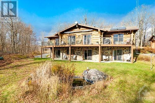 Scandinavin-style log home with 5 bedrooms, 4 with ensuites and walkouts. - 921 Norwood Road, Westport, ON - Outdoor With Deck Patio Veranda