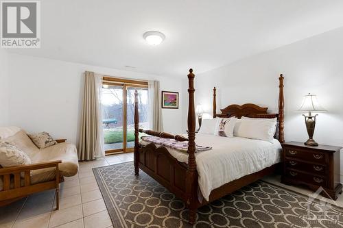 Lower level 5th bedroom walkout to deck - 921 Norwood Road, Westport, ON - Indoor Photo Showing Bedroom