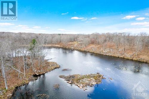 Serene spring-fed lake-pond for kayaking, skating and snowshoeing - 921 Norwood Road, Westport, ON - Outdoor With Body Of Water With View