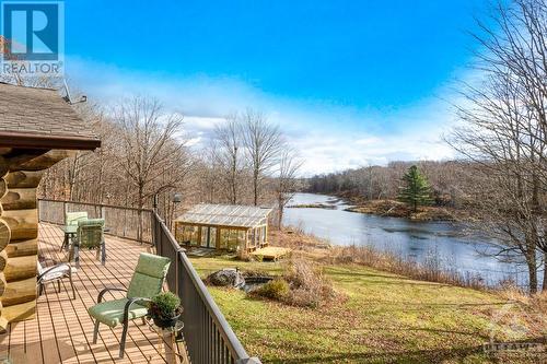 Expansive 50' upper deck overlooking gardens and lake-pond - 921 Norwood Road, Westport, ON - Outdoor With Body Of Water With View