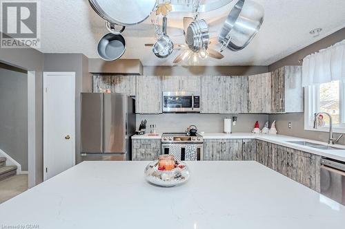 Kitchen featuring sink, a textured ceiling, and appliances with stainless steel finishes - 727 Zermatt Drive, Waterloo, ON - Indoor Photo Showing Kitchen