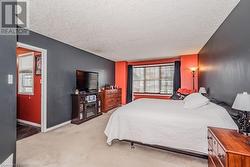 Carpeted bedroom featuring a textured ceiling - 