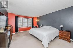 Bedroom featuring light colored carpet and a textured ceiling - 