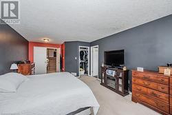 Carpeted bedroom featuring a textured ceiling - 