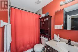 Full bathroom featuring shower / bath combo, vanity, and toilet - 