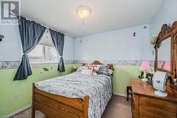 Bedroom featuring carpet floors and a textured ceiling - 