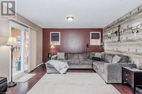 Living room with hardwood / wood-style floors and a textured ceiling - 727 Zermatt Drive, Waterloo, ON - Indoor Photo Showing Living Room