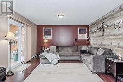 Living room with hardwood / wood-style floors and a textured ceiling - 