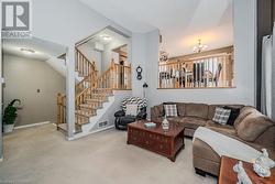 Carpeted living room with vaulted ceiling and a notable chandelier - 