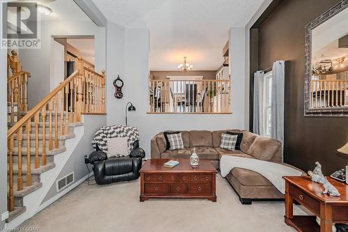 Living room with light colored carpet and a notable chandelier - 727 Zermatt Drive, Waterloo, ON - Indoor Photo Showing Living Room